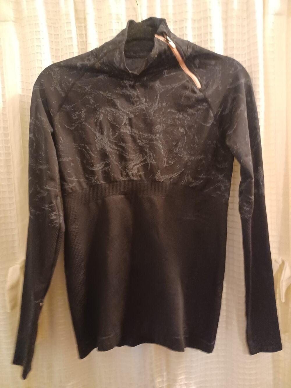 Fabletics Amelie Asymmetrical 1/4 Zip Pullover in a black marbled jacquard patte